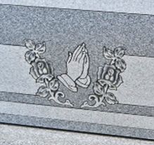 Bold deep-cut lettering on polished granite surface